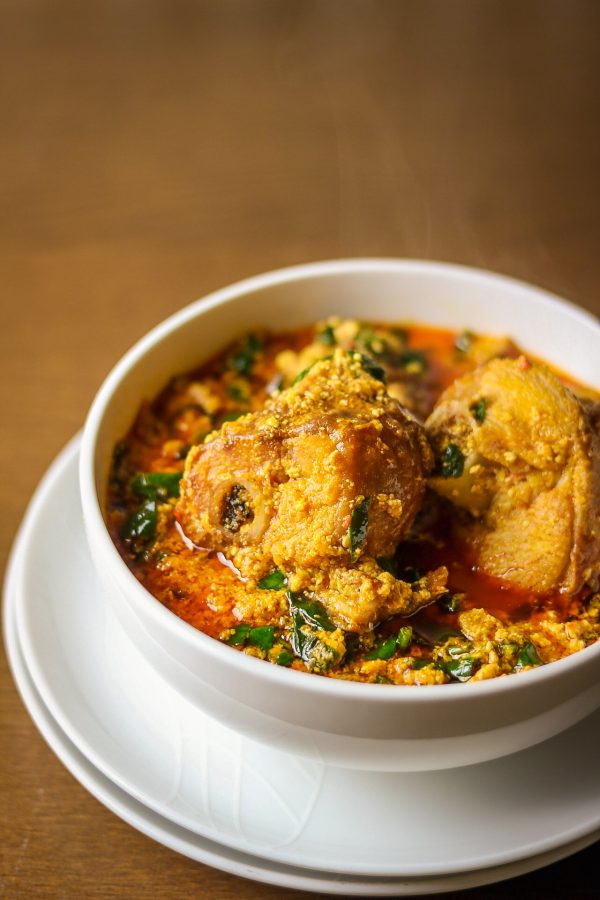 Top view of rich Nigerian Egusi Soup with spinach and meat